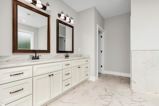 bathroom featuring tile floors, vanity with extensive cabinet space, and dual sinks