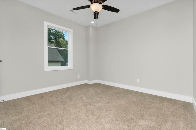 spare room with carpet and ceiling fan