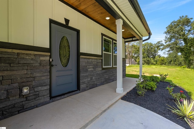 view of exterior entry with a lawn