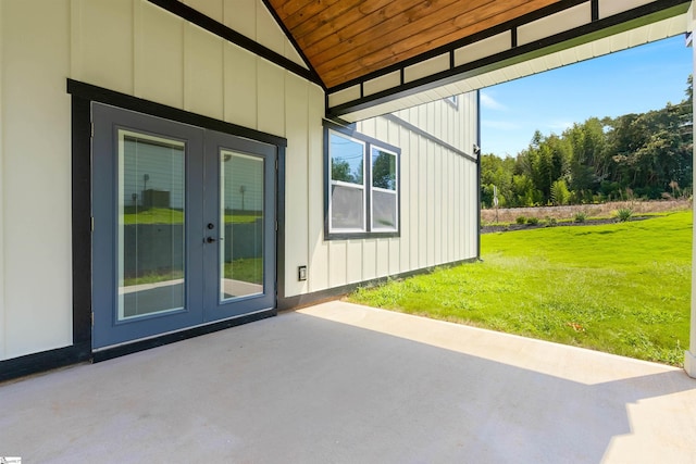 view of home's exterior featuring a patio area, a yard, and french doors