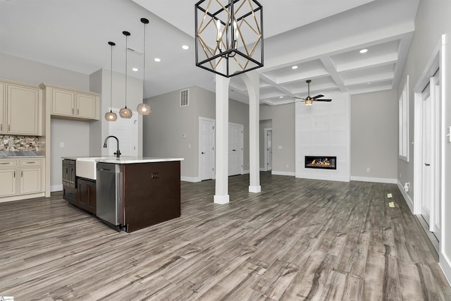 kitchen with coffered ceiling, light hardwood / wood-style flooring, cream cabinetry, and decorative light fixtures