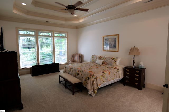 bedroom featuring a raised ceiling, light carpet, crown molding, and visible vents