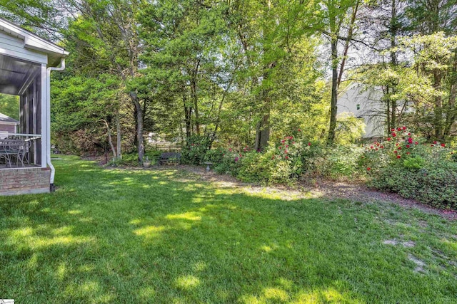 view of yard featuring a sunroom