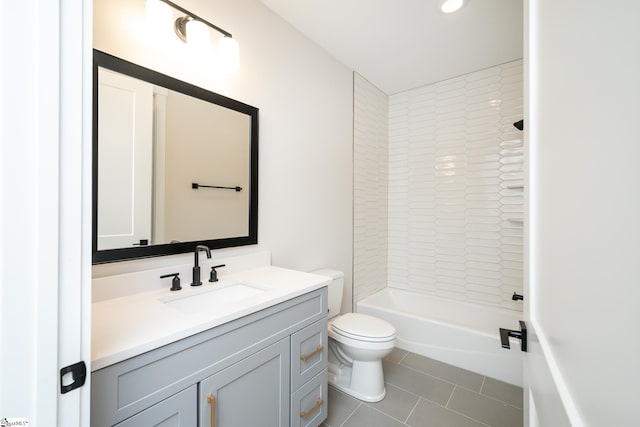 full bathroom featuring toilet, vanity with extensive cabinet space, tiled shower / bath, and tile flooring