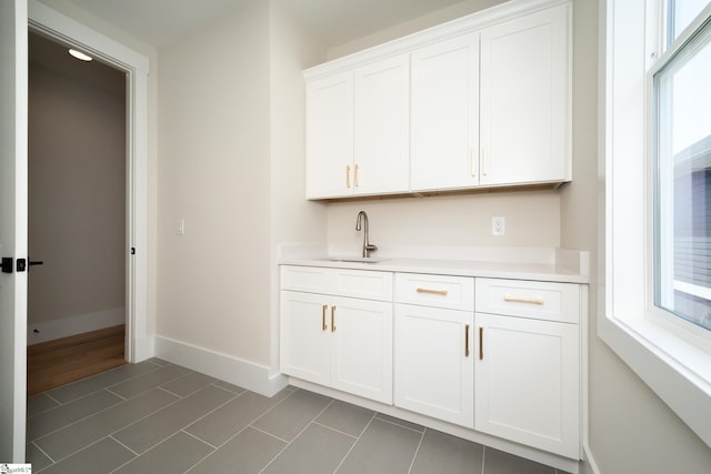 kitchen with white cabinets, sink, and dark wood-type flooring