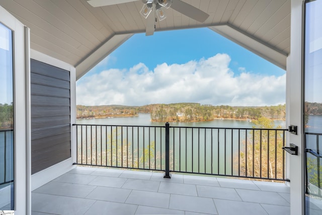 balcony featuring ceiling fan and a water view