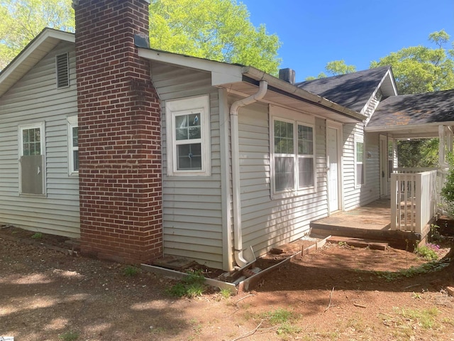 view of side of home featuring a wooden deck