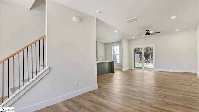 interior space featuring sink, ceiling fan, and light hardwood / wood-style floors