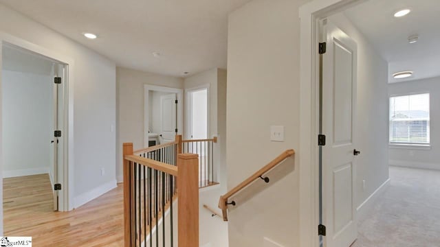 hallway featuring light colored carpet