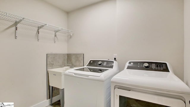 clothes washing area featuring washer and dryer