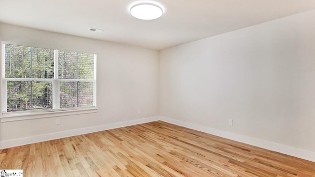 empty room with light hardwood / wood-style flooring