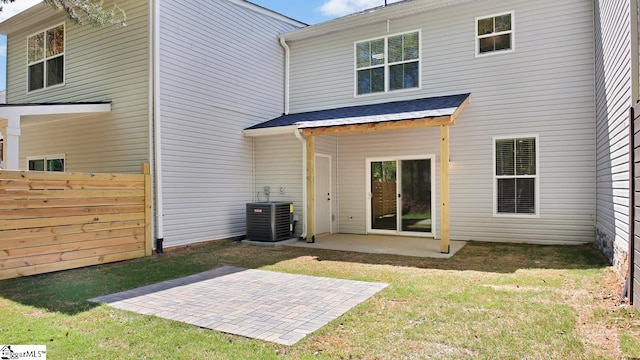 back of property with a patio, a yard, and central air condition unit