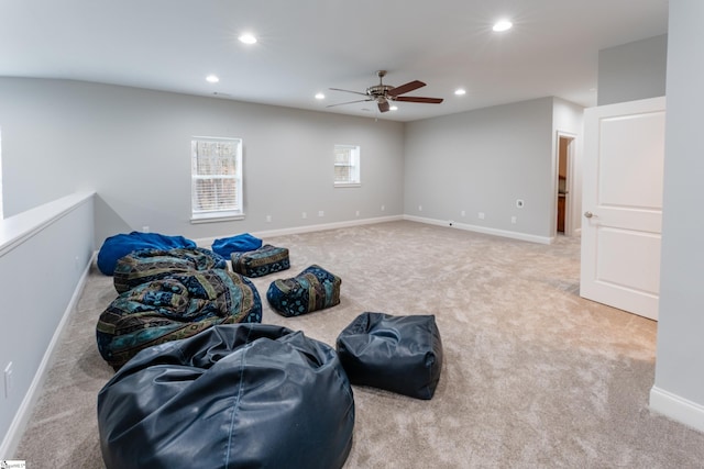 carpeted living room with ceiling fan