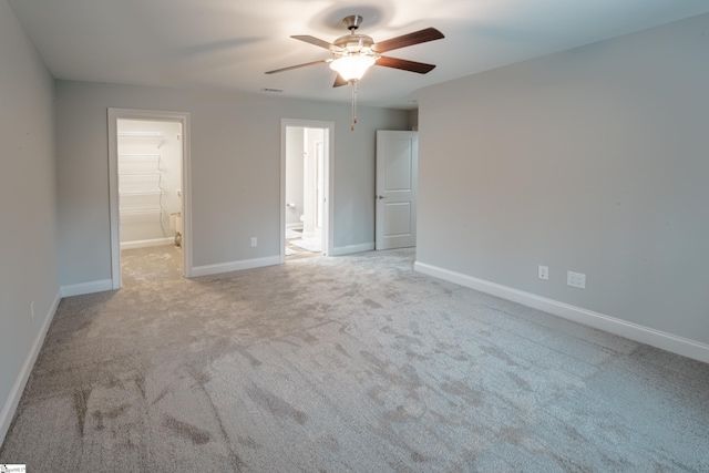 spare room featuring ceiling fan and light carpet