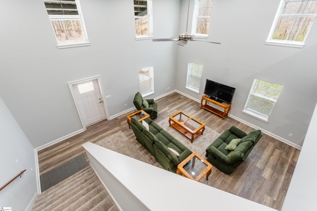 living room featuring a healthy amount of sunlight, hardwood / wood-style flooring, and a high ceiling