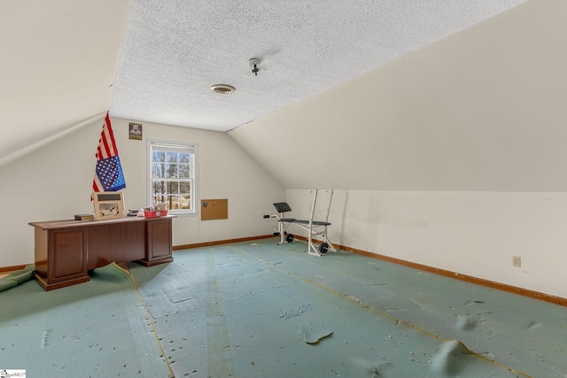 bonus room featuring vaulted ceiling and a textured ceiling