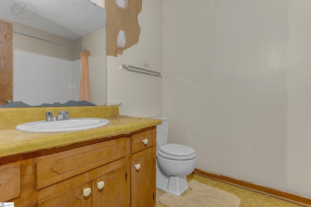 bathroom featuring toilet and vanity