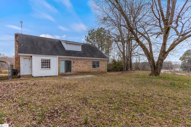 rear view of property featuring a yard