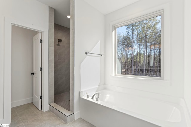 bathroom with independent shower and bath and tile patterned flooring