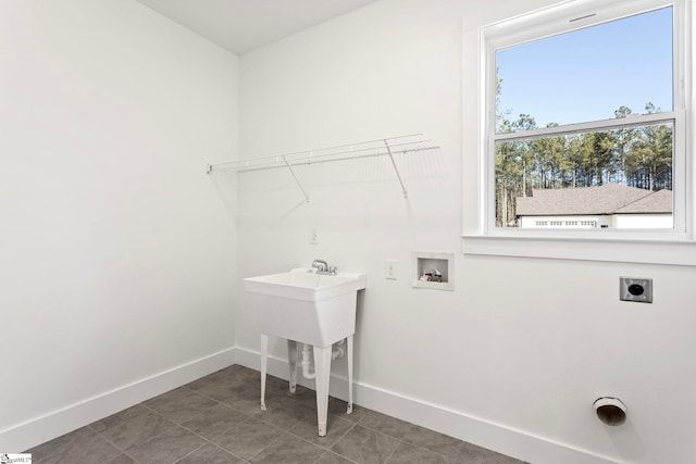 laundry room featuring dark tile patterned flooring, hookup for a washing machine, and electric dryer hookup