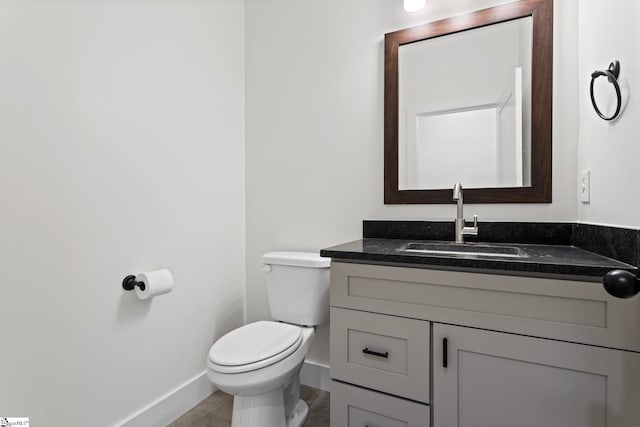 bathroom with vanity, toilet, and tile patterned flooring