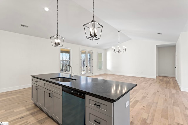 kitchen featuring sink, gray cabinets, hanging light fixtures, an island with sink, and stainless steel dishwasher