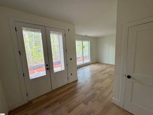 doorway to outside featuring light hardwood / wood-style floors and french doors