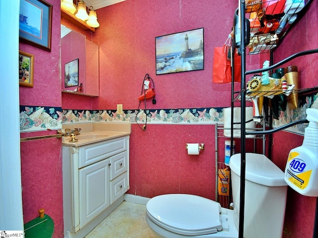 bathroom with vanity, tile floors, and toilet