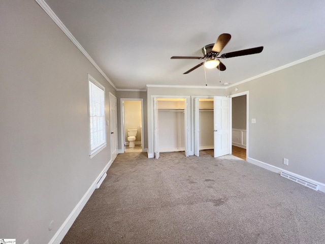 unfurnished bedroom featuring ceiling fan, crown molding, and carpet floors