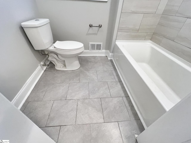 bathroom with toilet and tile floors