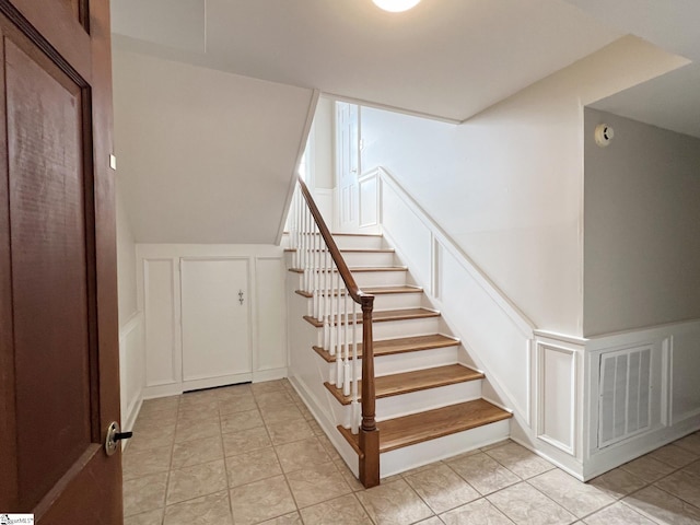 staircase with light tile floors