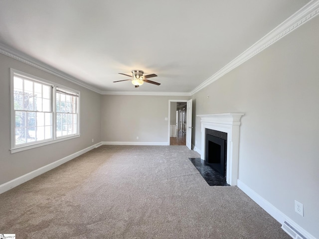 unfurnished living room featuring ceiling fan, crown molding, and carpet flooring