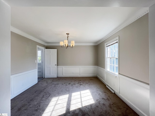 carpeted empty room with crown molding and a chandelier