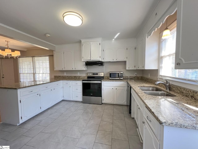 kitchen with appliances with stainless steel finishes, light tile floors, white cabinets, sink, and decorative light fixtures