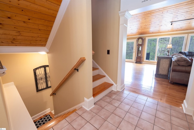 stairs featuring wood ceiling, crown molding, and hardwood / wood-style floors