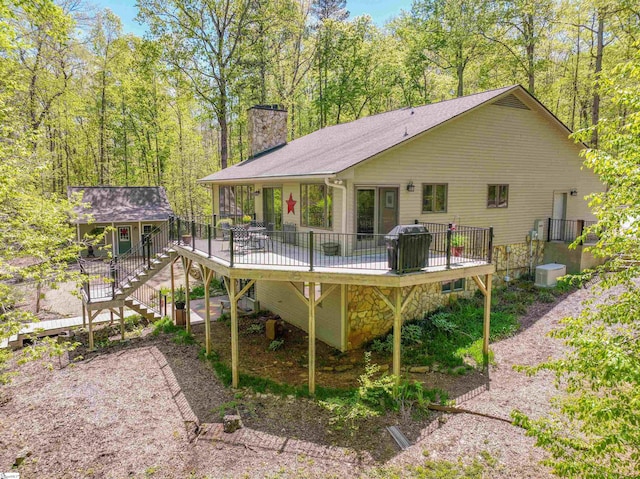 rear view of house featuring a wooden deck