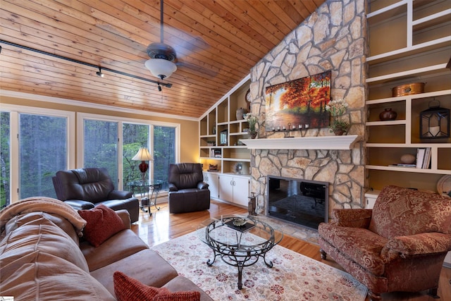 living room with wood ceiling, built in features, light hardwood / wood-style flooring, a fireplace, and vaulted ceiling