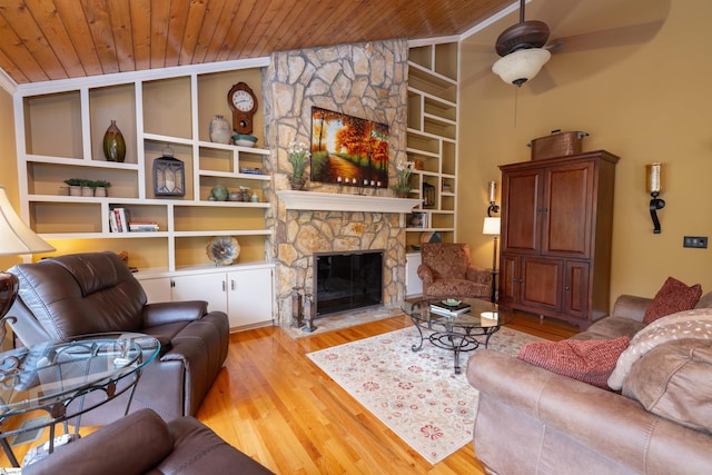 living room with light wood-type flooring, ceiling fan, wooden ceiling, and a stone fireplace