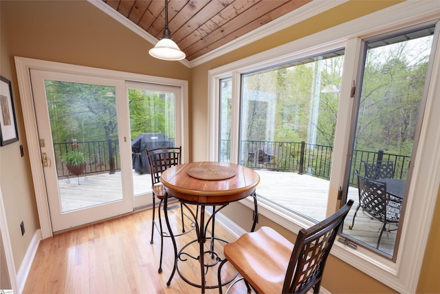 dining area with light wood-type flooring, crown molding, wood ceiling, and vaulted ceiling