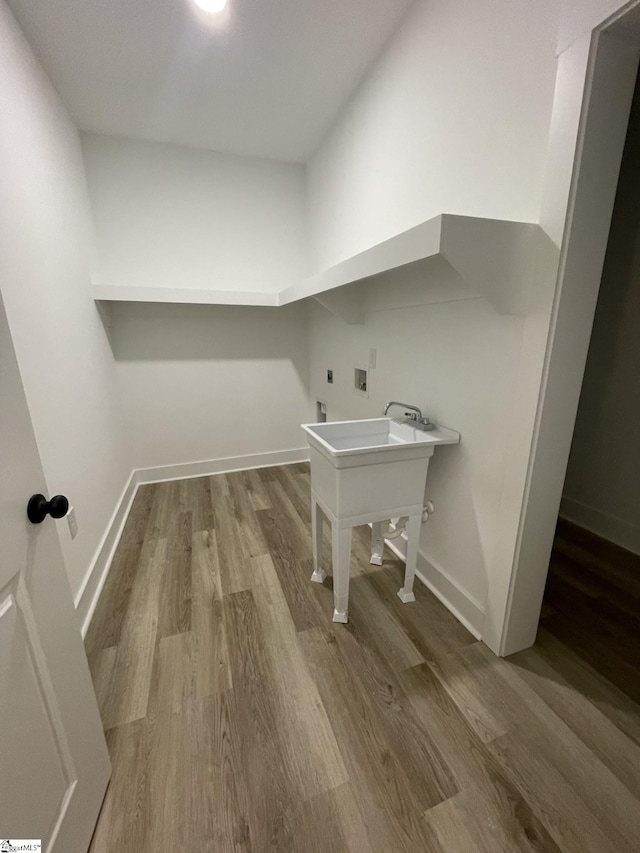 clothes washing area with washer hookup, hardwood / wood-style floors, and electric dryer hookup