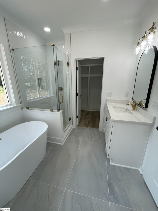 bathroom featuring vanity and shower with separate bathtub