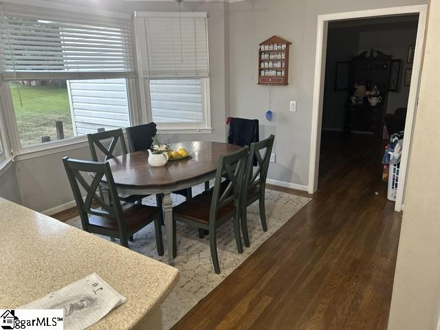 dining room with dark hardwood / wood-style flooring