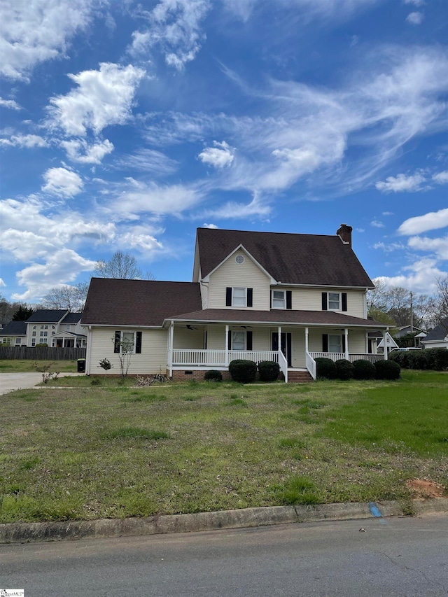 view of front of property with a front lawn and covered porch