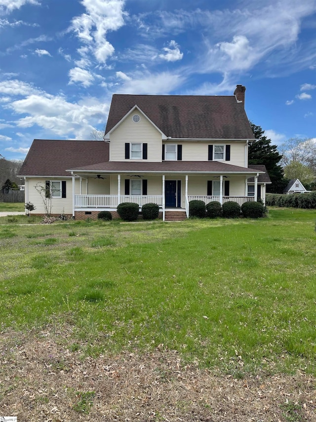 view of front of home with covered porch and a front lawn