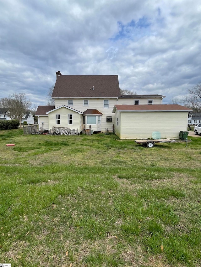 back of house with a yard