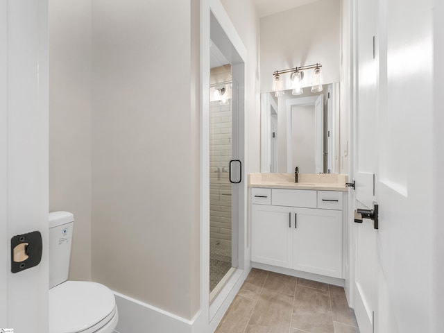 bathroom with tile patterned floors, vanity, an enclosed shower, and toilet