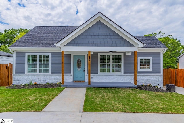 view of front of property with covered porch and a front lawn