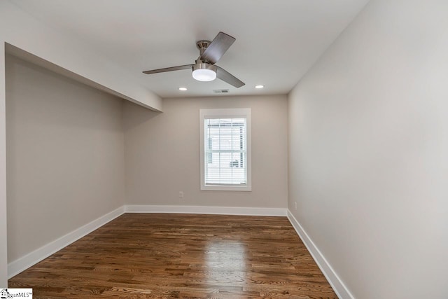 spare room featuring ceiling fan and dark wood-type flooring