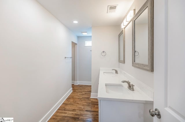 bathroom with hardwood / wood-style floors and double sink vanity