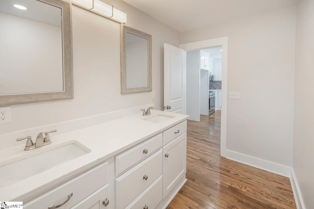 bathroom featuring hardwood / wood-style floors and double vanity